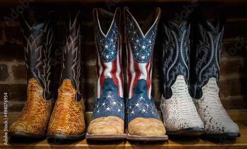 Photo Closeup of Cowboy boots decorated with the American flag on sale in shops in dow