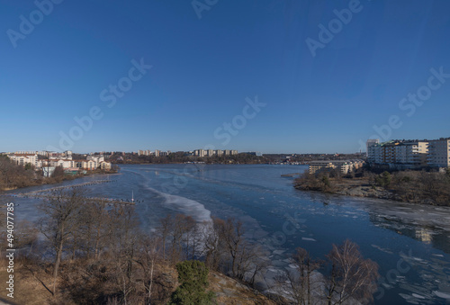 Bridge view over the bay Ulvsundasjön with apartment houses at the waterfront a sunny spring day in Stockholm