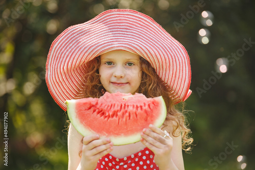 Cute girl eatind watermelon photo
