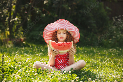 Cute girl eatind watermelon photo