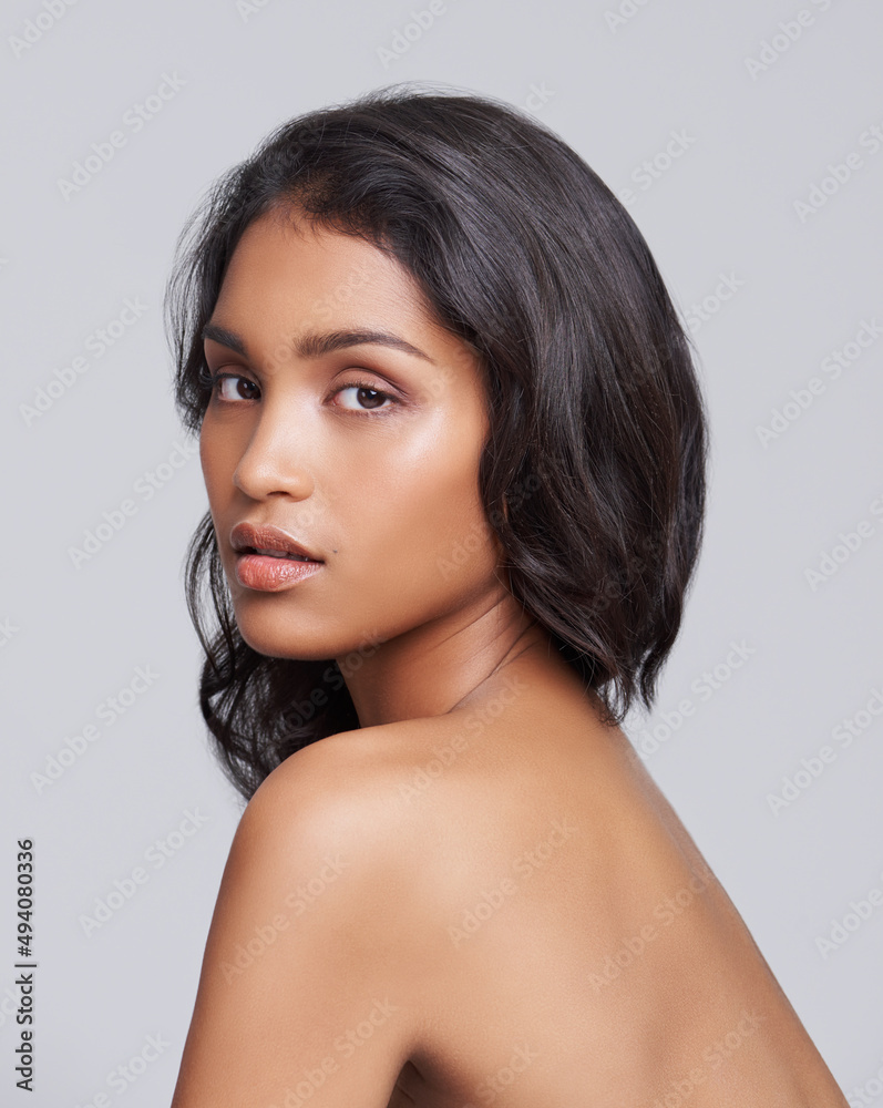 All natural beauty. Shot of a beautiful young posing over a gray background. All natural beauty. Shot of a beautiful young posing over a gray background.