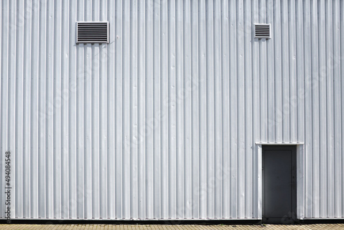 White industrial building or shop, outside wall fragment, door and ventilation ... 