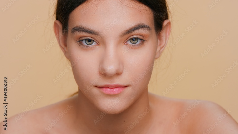 Close-up beauty portrait of young attractive woman on beige background | Skin care concept Close-up beauty portrait of young attractive woman on beige background | Skin care concept