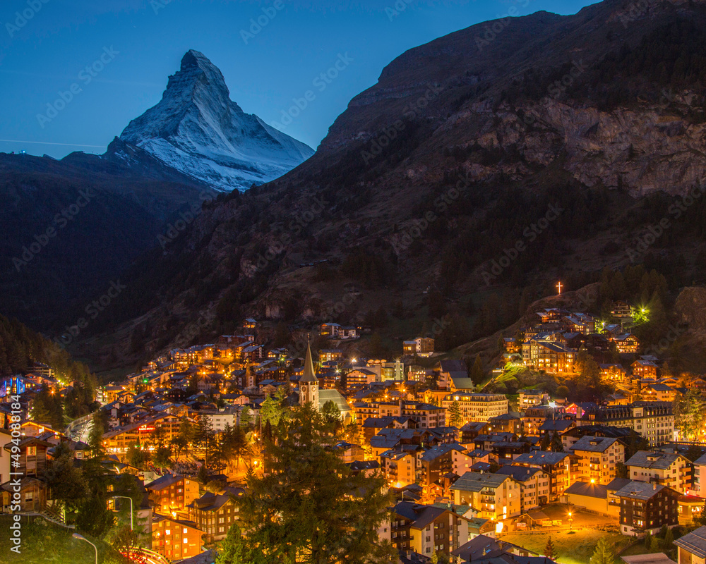 The night lights of Zermatt, Switzerland with the Matterhorn looming overhead - landscape format