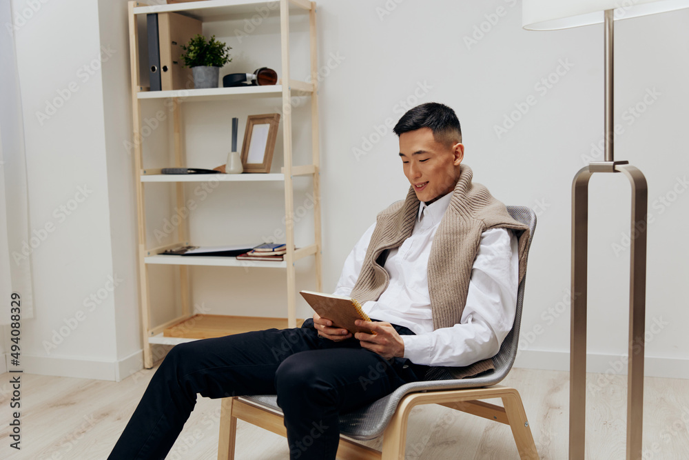 teenager in the room with the tablet in the chair rest interior teenager in the room with the tablet in the chair rest interior