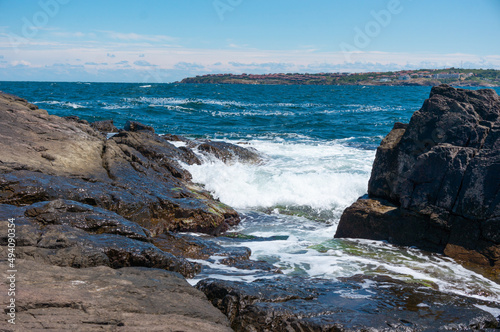 Sea surf day landscape. Sea waves with white foam breaks on stones. Sozopol. Bulgaria