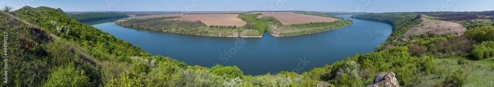 Amazing spring view on the Dnister River Canyon with picturesque rocks, fields, flowers. This place named Shyshkovi Gorby, Nahoriany, Chernivtsi region, Ukraine. Amazing spring view on the Dnister River Canyon with picturesque rocks, fields, flowers. This place named Shyshkovi Gorby, Nahoriany, Chernivtsi region, Ukraine.