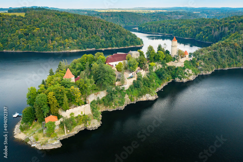 Panoramic view of Zvikov Castle on the hill with trees surrounded by river Vltava and Otava in South Bohemia region in Czech Republic. Pine or spruce forest on the background  photo