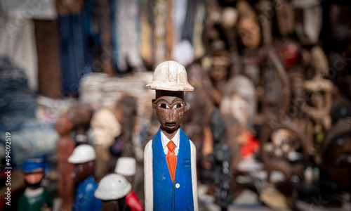 Close up of hand carved wooden statue of working man of African decent.