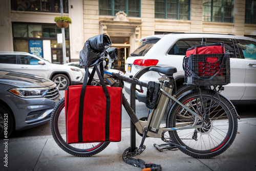 Photography Electric food delivery bicycle locked to bike stand in Manhattan, New York City