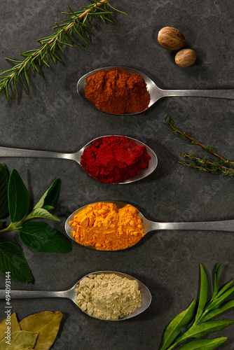 Spices in spoons in a stone table