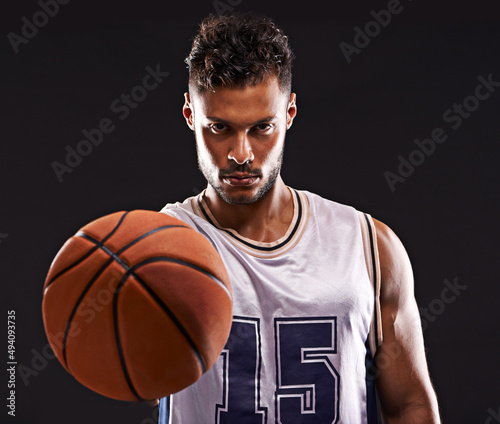 Ready to play. Studio shot of a basketball player against a black background. © Duncan M/peopleimages.com