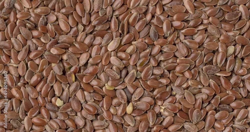 Top view, closeup of brown linseed seeds. Food backdrop Top view, closeup of brown linseed seeds. Food backdrop
