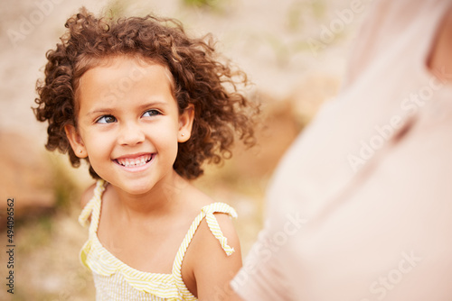 Walking through nature with my mom. Shot of a little girl walking with her mom. photo