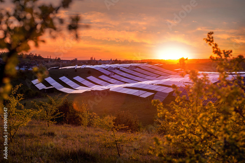 solar panels, wavy hills at sunset, warm light, illustration of alternative e...