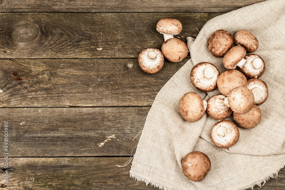 Fresh brown champignons in a wicker basket. Raw ingredients for cooking vegan food Fresh brown champignons in a wicker basket. Raw ingredients for cooking vegan food