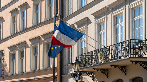 Konstfotografi The flags of France and the European Union flutter in the wind on the old wall o