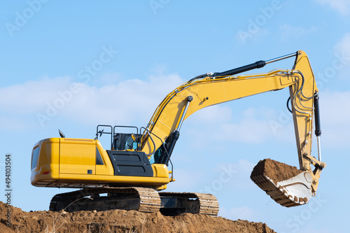 yellow excavator at construction site
