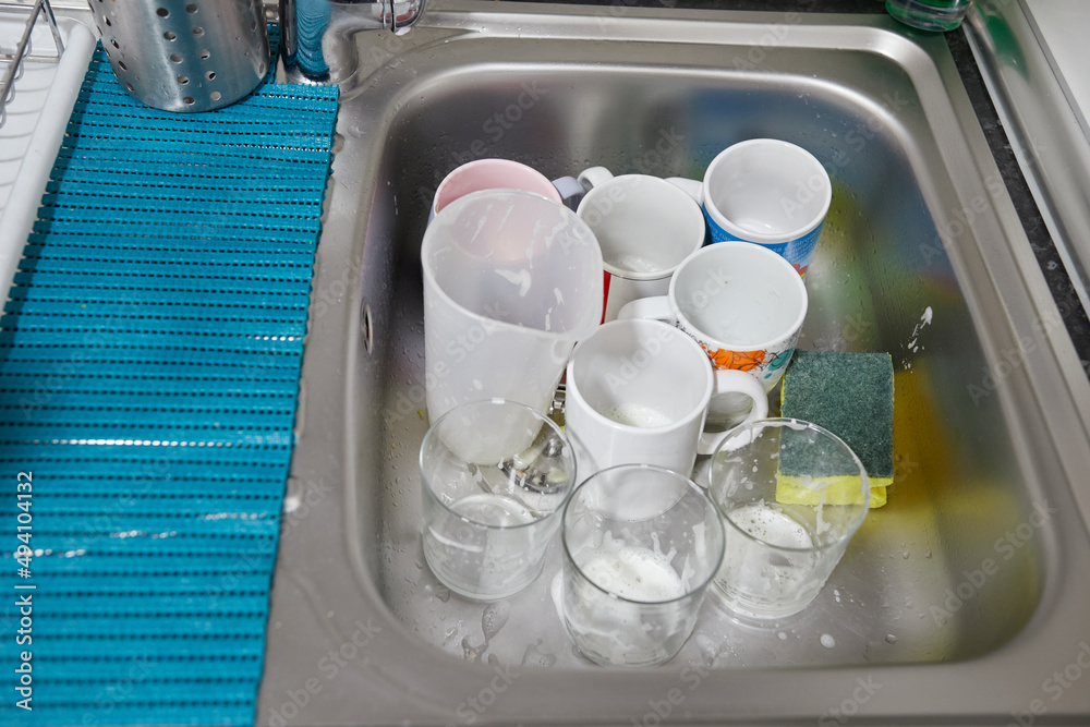 Sink with glasses and cups with soap Sink with glasses and cups with soap