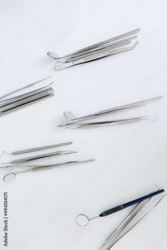 Top view of various organized dentist equipment in a white background Top view of various organized dentist equipment in a white background