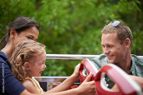 Are you ready to see Disneyland. Shot of a happy young family sitting on a bus.