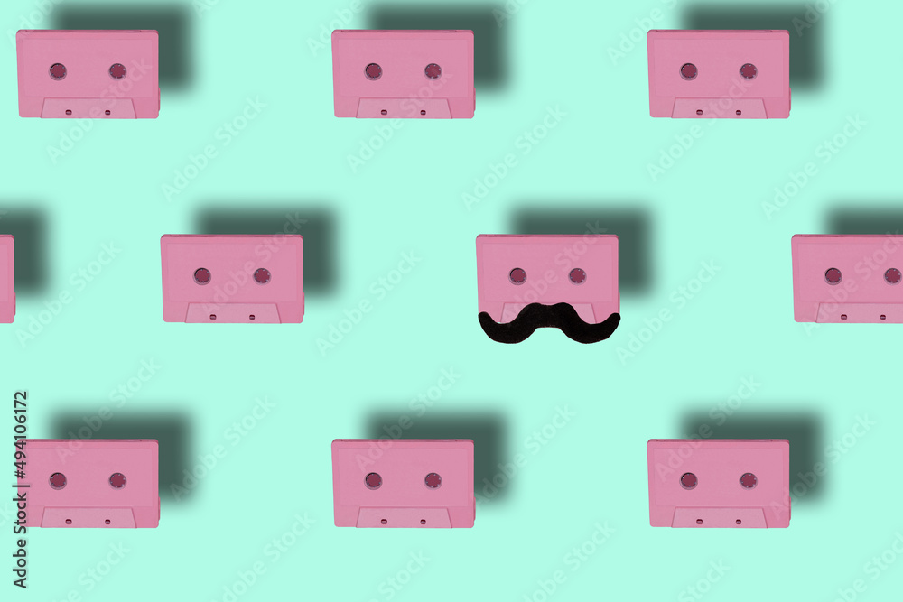 break the pattern, pink cassettes on the background and one has a mustache, art fashion pastel blue background