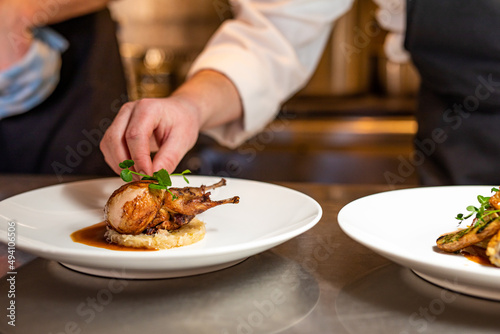 Obraz na płótnie quail plated and prepared in kitchen by chef