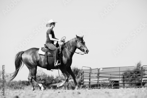 Horse gallop with cowgirl for western lifestyle in black and white on ranch.