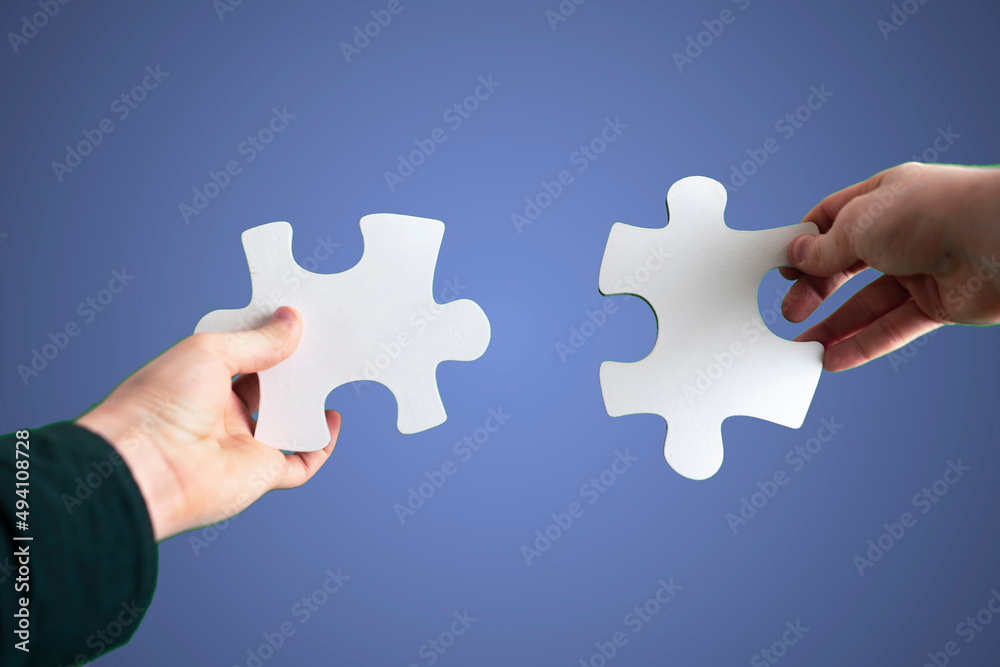 the human hands connect two puzzle pieces together, desicion making, sky background the human hands connect two puzzle pieces together, desicion making, sky background