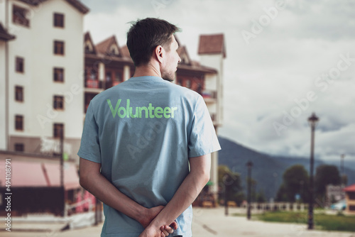 a young male volunteer activist doing work outside  altruism and teamwork concept