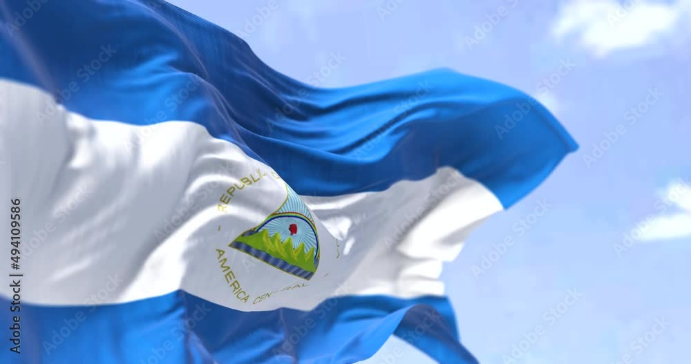 Detail of the national flag of Nicaragua waving in the wind on a clear day