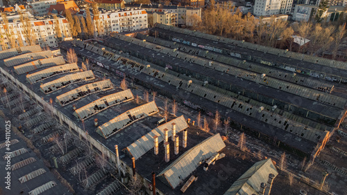 Old factory, abandoned greenhouses in the middle of the city top view. Industrial drone photo