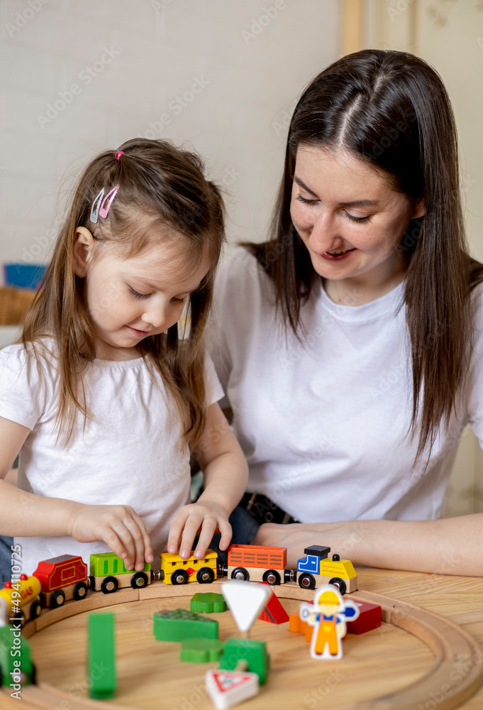 Montessori material. Mom and daughter learn transport through the game. Wooden railroad. Montessori material. Mom and daughter learn transport through the game. Wooden railroad.