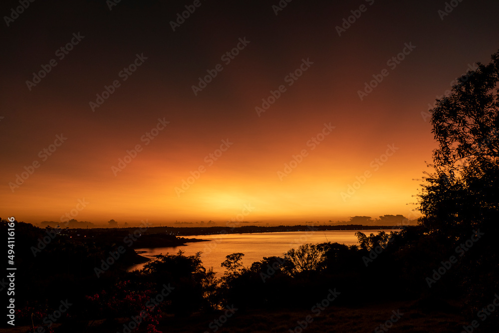 Silhouette of trees with a beautiful sunrise in Anchieta, State of Espirito Santo, Brazil