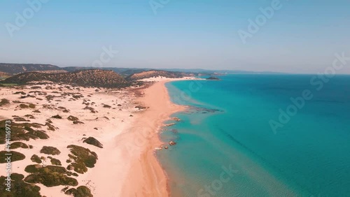 Aerial 4k Karpaz Golden Beach with crystal clear water and sandy coastline in North Cyprus, which offer you tropical exotic beach feeling with its natural untouched beauty in Cyprus Island. photo