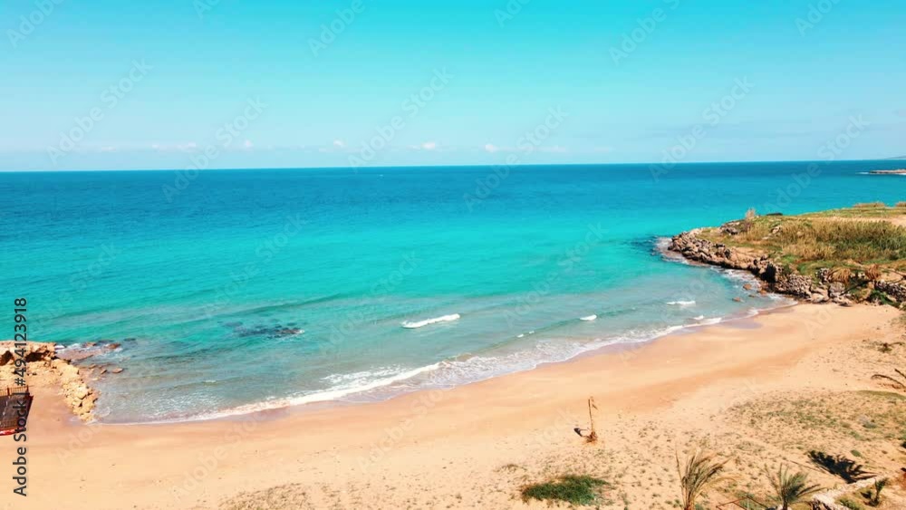 Aerial 4k Sandy Beach with crystal clear water and sandy coastline in North Cyprus, which offer you tropical exotic beach feeling with its natural untouched beauty in Cyprus Island. Aerial 4k Sandy Beach with crystal clear water and sandy coastline in North Cyprus, which offer you tropical exotic beach feeling with its natural untouched beauty in Cyprus Island.