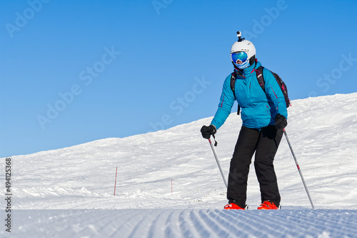 Ski, skier, sun and winter fun - woman enjoying ski vacation. winter, leisure, sport and people concept. Young woman in ski goggles at ski resort