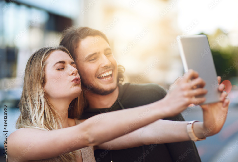 Lots of love from your favorite couple. Portrait of a happy young couple taking a selfie on their digital tablet. Lots of love from your favorite couple. Portrait of a happy young couple taking a selfie on their digital tablet.