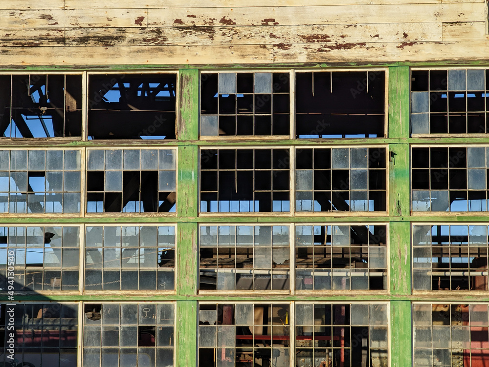 Old factory building with some broken glass window panes 
