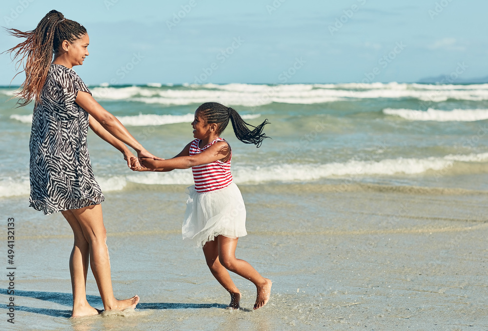 Making some summertime memories. Shot of a mother and her little daughter enjoying some quality time together at the beach.