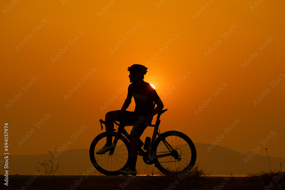 silhouette of a cyclist on sunset, the scenery sunrise in the morning in Thailand. silhouette of a cyclist on sunset, the scenery sunrise in the morning in Thailand.