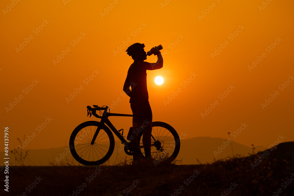 silhouette of a cyclist on sunset, the scenery sunrise in the morning in Thailand. silhouette of a cyclist on sunset, the scenery sunrise in the morning in Thailand.