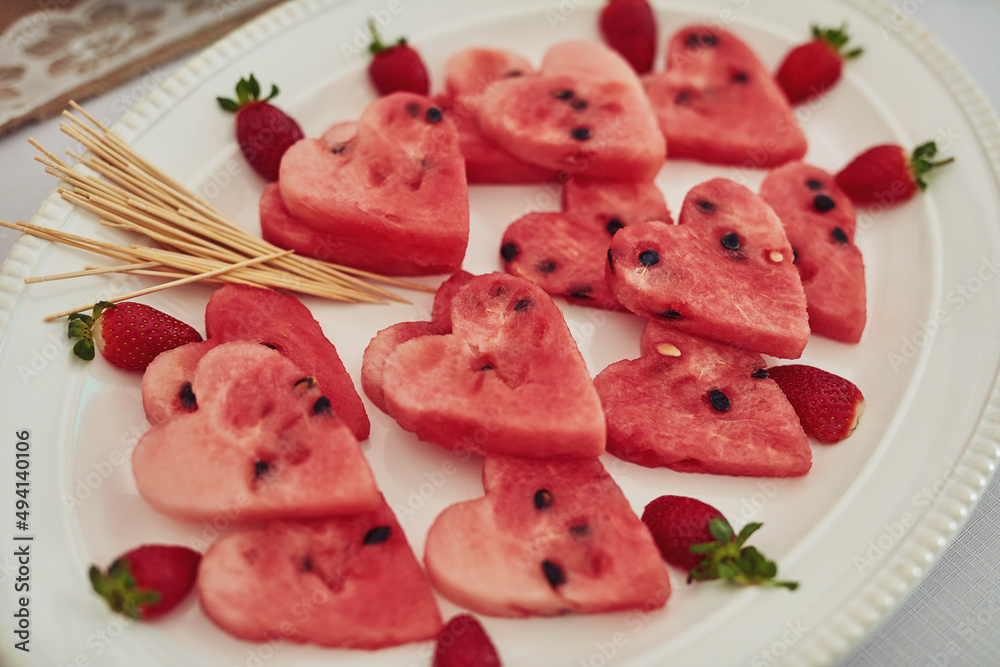 Healthy and full of heart. High angle shot of watermelon cut into heart shapes on a table at a tea party inside.