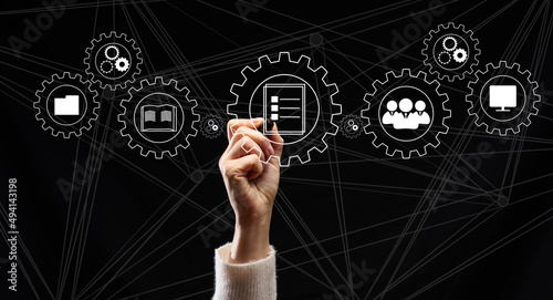 Control and management of business processes in the enterprise for efficient operation and increased profits. Concept with manager's hand and gears on holographic screen