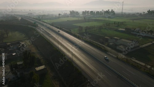 Aerial Over Hazara M 15 Motorway Through Rural Misty Landscape In Abbottabad. Dolly Back photo