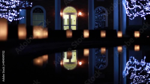 Fountain Reflecting Christmas Lights And Candles At Elon University photo