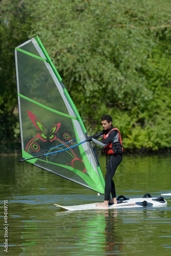 novice male windsurfer doing routine photo