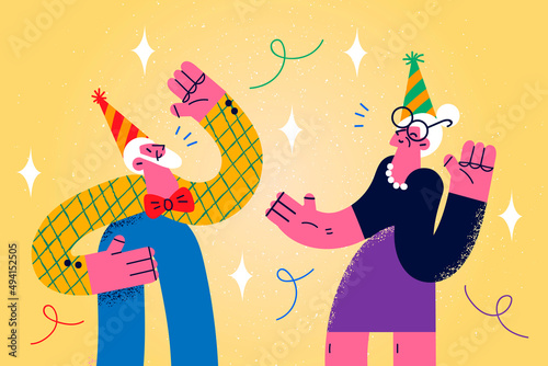 Happy old grandparents have fun celebrating together 