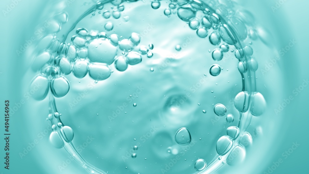 Top view macro shot of transparent liquid pouring into beaker creates a lot of bursting bubbles on cyan background | Abstract face care cosmetics formulation concept