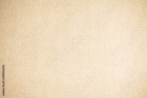 Brown recycled kraft cardboard background. Cream paper texture, Old vintage page grunge with vignette.
